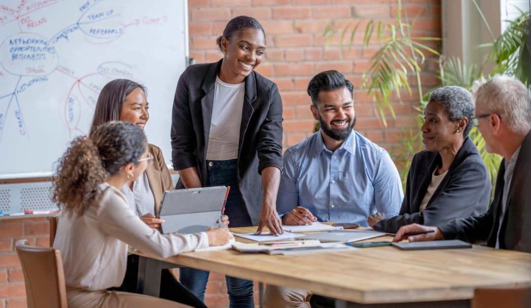 Diverse team of professionals in a corporate meeting, actively listening and building trust through open conversation.